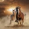 Two wild chestnut horses running together in dust