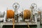 Two winches with orange rope on a ferry, white cloudy backgrond