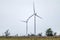 Two wind electro generators standing in field