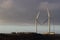 Two wind farms against background of setting sun. Alternative power supplies. Canary islands