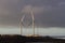 Two wind farms against background of setting sun. Alternative power supplies. Canary islands