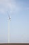 Two wind turbines on agricultural ground with clear sky in background