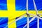 Two Wind Turbines for alternative energy on Sweden flag background. Wind turbines generating electricity