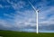 Two wind turbines generating renewable energy on a clear windy day