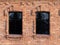 Two windows of the old mansion 19 century with brown bricks wall