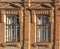 Two windows of the old mansion 19 century with brown bricks wall