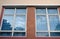 Two windows with reflection of the azure blue skies on the glass panes