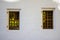 Two Windows with wooden shutters on the white stone wall of the medieval Novodevichy convent building