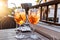 Two wine glass of cold cocktail Aperol spritz on table