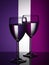 Two wine glasses silhouette full on colored background. Alcohol beverage