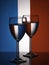 Two wine glasses silhouette full on french flag background. Alcohol beverage