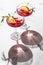 Two wineglass of Pomegranate iced cocktail with rosemary and lemon on white marble background isolated with clear