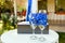 Two wineglasses with blue ribbon and gift box on wedding ceremony