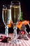 Two wineglasses of champagne and new year`s decoration and cinnamon on the bokeh background