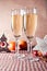 Two wineglasses and Christmas decoration on the red checkered background