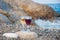 Two wineglasses with red, white drinks stay on grey stone on sea beach