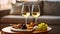 Two wineglasses of vintage chardonnay with delicious appetizers. Couple of glasses of white wine, italian breadsticks, and grapes