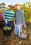 Two winemakers with buckets of ripe grapes during harvest