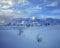 Two winter lonely snowy fir trees on mountainside blue sky background