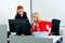 Two woman colegues working on computer in office