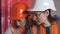 Two woman engineers checking technical data of heating system equipment in a boiler room