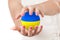 Two Woman Hands Protecting Ukraine Flag Earth Globe Sphere.