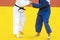 Two woman judo fighters in white and blue uniform. Professional sport concept