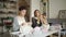 Two woman knitter making wool fabric sitting at table in textile workshop