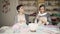 Two woman knitter talking and smiling at work table in studio