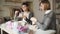 Two woman knitter working together in textile workshop. Knitting hands