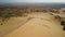 Two woman man drone pilot traveler standing sand desert dune mountain ridge