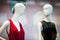 Two woman mannequins in shopping window in store