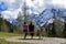 Two woman sitting on bench and watching beautiful mountain view of German Alps