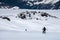 Two woman snowboarder climbs the mountain through the snow backcountry with a snowboard behind her shoulders. Climb the