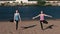 Two woman stretching yoga standing on the beach by the river in the city. Beautiful city view. Balance pose.