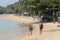 Two woman walking on Bophut beach  in Koh Samui, Thailand..