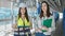 Two women architect and worker holding clipboard and touchpad working at street