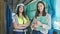 Two women architect and worker holding clipboard working at street