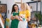 Two women artists smiling confident drawing at art studio