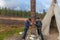 Two women ask the gods of happiness, health, wealth in alley of the gods, Sami, saami village on the Kola Peninsula, Russia.