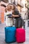 Two women with baggage checking route outdoors