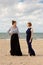 Two women beach sand sea talking, De Panne, Belgium