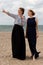 Two women beach sand sea talking, De Panne, Belgium