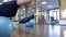 Two women black sportswear do exercises on fitball in gym.