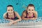 Two women at the border of pool at the gym. Mom and daughter look happy, fashionable and fit.