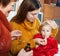 Two women caring for unwell baby