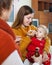 Two women caring for unwell toddler