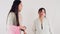 Two women in casual attire fighting arguing and upset in a party on white background