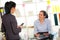 Two women chat to each other in the office.