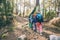 Two women and a child walk in the forest